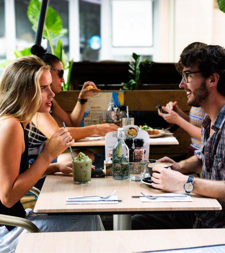 Friends sharing brunch together at a table in Glider Garden, Potts Point